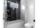 Bathroom features a toilet and bathtub with glass enclosure at 2972 Lake Saxon Dr, Land O Lakes, FL 34639