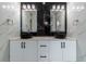 Double vanity bathroom with black sinks and marble tile at 2972 Lake Saxon Dr, Land O Lakes, FL 34639