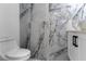 Modern bathroom with marble tile and a free-standing bathtub at 2972 Lake Saxon Dr, Land O Lakes, FL 34639