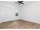 Bedroom with wood-look floors, a window, and a ceiling fan at 2972 Lake Saxon Dr, Land O Lakes, FL 34639