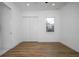 Bedroom with wood-look flooring and white closet doors at 2972 Lake Saxon Dr, Land O Lakes, FL 34639