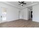 Primary bedroom with hardwood floors and door to en-suite at 2972 Lake Saxon Dr, Land O Lakes, FL 34639