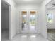 Bright entryway with double doors and marble flooring at 2972 Lake Saxon Dr, Land O Lakes, FL 34639