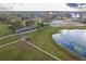 Aerial view of property with stables, riding arena, and pond at 2972 Lake Saxon Dr, Land O Lakes, FL 34639