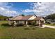 New home exterior featuring stone accents and a modern garage door at 2972 Lake Saxon Dr, Land O Lakes, FL 34639