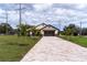 Newly constructed home with a paver driveway and landscaping at 2972 Lake Saxon Dr, Land O Lakes, FL 34639