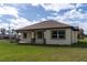 Tan house with brown accents and a covered porch at 2972 Lake Saxon Dr, Land O Lakes, FL 34639