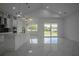 Open concept kitchen with white cabinets and stainless steel appliances at 2972 Lake Saxon Dr, Land O Lakes, FL 34639