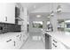 Modern kitchen with white cabinets, stainless steel appliances, and marble floors at 2972 Lake Saxon Dr, Land O Lakes, FL 34639