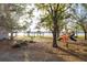 Lakeside playground with swings, slides, and shaded picnic areas at 2972 Lake Saxon Dr, Land O Lakes, FL 34639