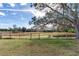 Landscaped backyard with privacy fence and pathway at 3050 Maple Trce, Tarpon Springs, FL 34688