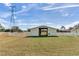 View of a charming yellow barn with white fencing at 3050 Maple Trce, Tarpon Springs, FL 34688