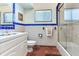 Small bathroom with white vanity, blue tile, and a shower at 3050 Maple Trce, Tarpon Springs, FL 34688