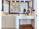 Bathroom with a double vanity, blue and white tile, and terracotta floor at 3050 Maple Trce, Tarpon Springs, FL 34688