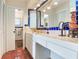 Double vanity bathroom with blue and white tile and terracotta flooring at 3050 Maple Trce, Tarpon Springs, FL 34688