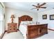 Bright bedroom featuring a large wooden bed frame and an ensuite bathroom at 3050 Maple Trce, Tarpon Springs, FL 34688