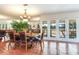 Bright dining area with a wood table and access to backyard at 3050 Maple Trce, Tarpon Springs, FL 34688