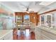 Charming dining area with a rustic wooden table, mural and access to the kitchen at 3050 Maple Trce, Tarpon Springs, FL 34688