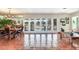 Spacious dining room with terracotta tile floors and large windows at 3050 Maple Trce, Tarpon Springs, FL 34688