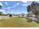 Ranch-style home with attached barn, surrounded by lush greenery at 3050 Maple Trce, Tarpon Springs, FL 34688