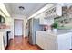 Bright kitchen with stainless steel appliances and terracotta tile floors at 3050 Maple Trce, Tarpon Springs, FL 34688