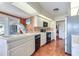 Kitchen with white cabinets, black appliances, and terracotta tile floor at 3050 Maple Trce, Tarpon Springs, FL 34688