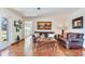 Relaxing living room with leather sofas and a view to the backyard at 3050 Maple Trce, Tarpon Springs, FL 34688