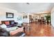 Spacious living room with terracotta tile floors, leather furniture, and formal dining area at 3050 Maple Trce, Tarpon Springs, FL 34688
