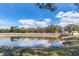 Serene pond with a wooden dock and lush greenery at 3050 Maple Trce, Tarpon Springs, FL 34688