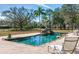 Inviting pool with stone waterfall feature at 3050 Maple Trce, Tarpon Springs, FL 34688