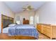 Main bedroom with wood furniture, ceiling fan and access to patio at 3133 Beaver Pond Trl, Valrico, FL 33596