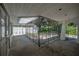 Enclosed front porch with wrought iron gate and concrete flooring at 3212 W Arch St, Tampa, FL 33607