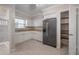 Kitchen with white cabinets, stainless steel refrigerator, and pantry at 3212 W Arch St, Tampa, FL 33607