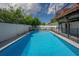 Sparkling clean pool with a large deck and fence at 3212 W Arch St, Tampa, FL 33607