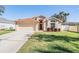 One-story house with a brown roof and attached garage, landscaped lawn at 3706 Lonewood Ct, Land O Lakes, FL 34638