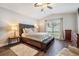 Main bedroom with king-size bed, wood floors, and large window at 3706 Lonewood Ct, Land O Lakes, FL 34638