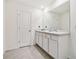Bathroom with double vanity and gray tile floor at 38296 Sonnet Landing Ave, Zephyrhills, FL 33540