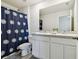 Bathroom with double vanity and blue shower curtain at 38296 Sonnet Landing Ave, Zephyrhills, FL 33540
