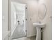 Simple bathroom with pedestal sink and access to another room at 38296 Sonnet Landing Ave, Zephyrhills, FL 33540