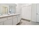 Bathroom with double vanity, shower, and tile floor at 38296 Sonnet Landing Ave, Zephyrhills, FL 33540