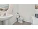 Clean and modern bathroom with pedestal sink and toilet at 38296 Sonnet Landing Ave, Zephyrhills, FL 33540