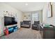 Bedroom with crib, armchair, and plenty of storage at 38296 Sonnet Landing Ave, Zephyrhills, FL 33540