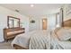Spacious bedroom with dresser and large bed at 38296 Sonnet Landing Ave, Zephyrhills, FL 33540