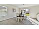 Bright dining area with table and chairs near sliding glass doors at 38296 Sonnet Landing Ave, Zephyrhills, FL 33540