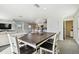 Bright dining room with farmhouse table and seating for six at 38296 Sonnet Landing Ave, Zephyrhills, FL 33540