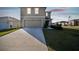 Two-story house with attached garage and manicured lawn at 38296 Sonnet Landing Ave, Zephyrhills, FL 33540