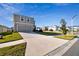 Two-story house with beige exterior, two-car garage, and a nicely landscaped lawn at 38296 Sonnet Landing Ave, Zephyrhills, FL 33540