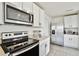 Modern kitchen with stainless steel appliances and white cabinets at 38296 Sonnet Landing Ave, Zephyrhills, FL 33540