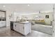 Open concept kitchen features stainless steel appliances and an island with seating at 38296 Sonnet Landing Ave, Zephyrhills, FL 33540