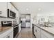 Modern kitchen with stainless steel appliances and white cabinetry at 38296 Sonnet Landing Ave, Zephyrhills, FL 33540